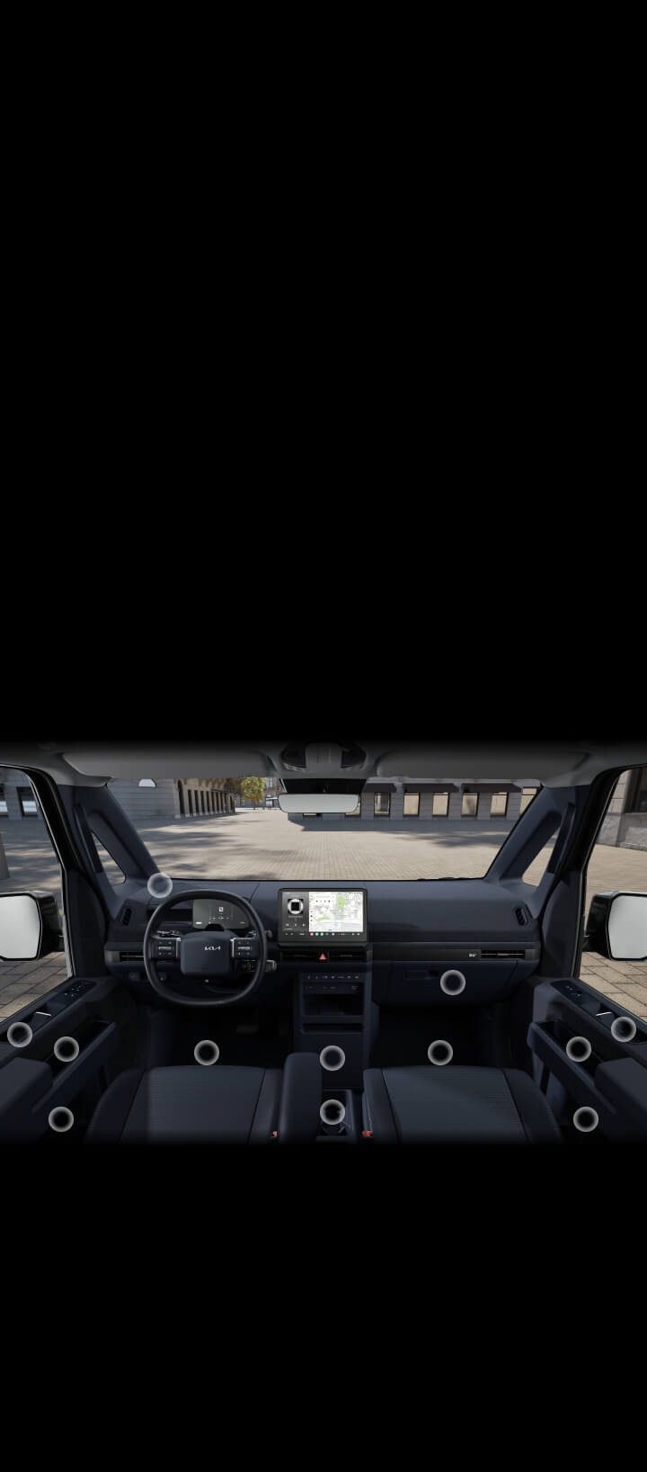 Innenansicht des Kia PV5 Cargo mit Fokus auf die zahlreichen versteckten Ablagefächer im Fahrer- und Beifahrerbereich